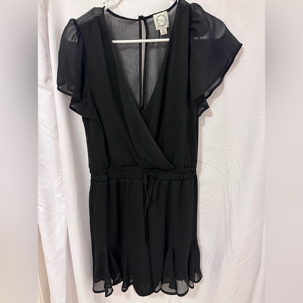 Black romper with frilly bottom. Size M.